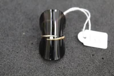 a small black object with a gold ring on it