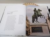an open book with a picture of a man on a horse on it