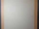 an empty picture frame sitting on top of a table next to a wall