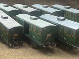 a lot of toy trains that are sitting on the ground