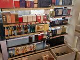 many different types of perfumes on display in a store