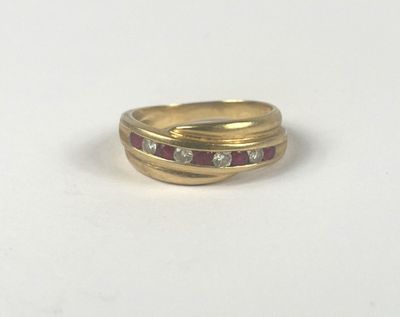 a close up of a gold ring with diamonds on a white surface