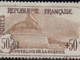 a stamp with a picture of a woman sitting on top of a box