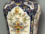 a blue and white vase with a bird on it
