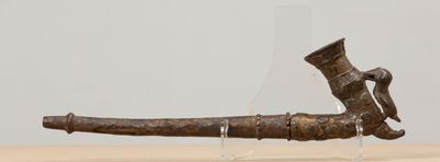 an old bronze pipe with a bird on it