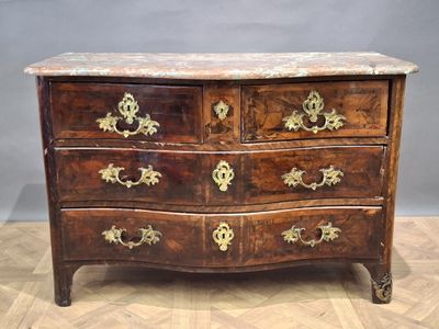 a marble top chest of drawers on a wooden floor
