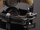 a watch that is sitting on top of a black table
