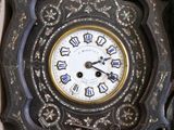 a box with a clock inside of it on the floor