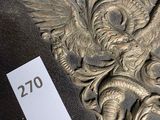 carvings of a dragon and a snake are on display in a museum