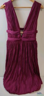 a picture of a purple dress hanging on a hanger