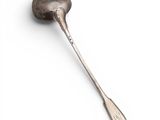 a close up of a spoon with a spoon handle on a white surface