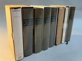 six books are lined up in a row on a table