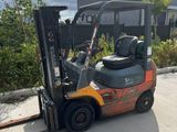 a picture of a forklift parked in front of a building