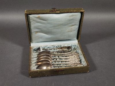 a silver spoon and spoon set in a box
