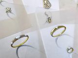 many different types of rings and necklaces on a table