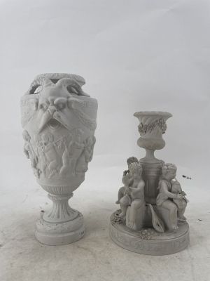 two statues of a man with a beard and a woman with a vase