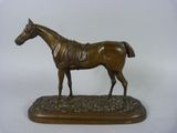 bronze statue of a horse on a wooden base on a white background