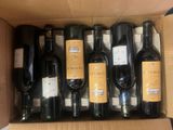 bottles of wine are in a cardboard box on a table