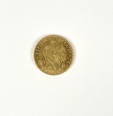 a close up of a gold coin on a white surface