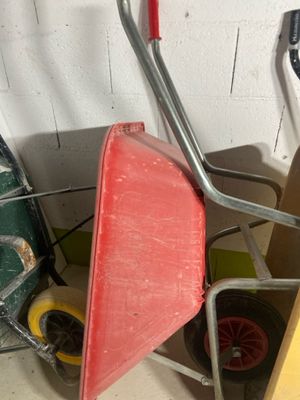 a wheelbarrow and a cart in a garage