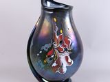 a black vase with a colorful design on it