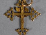 an image of a gold cross with a bird on it