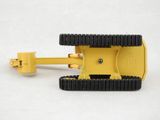 a close up of a small yellow machine on a white surface