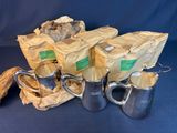 five silver pitchers and two silver cups on a blue background