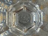 a clear glass bowl with a silver lid on a table
