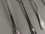 several spoons and spoon spoons are lined up on a table