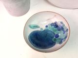 a small bowl with a blue and green design on it