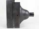 a close up of a metal object on a white surface