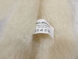 white wool with a label on it that says 100 % mohair