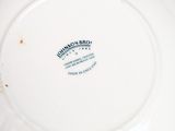 a white plate with a blue and white design on it