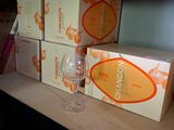 several boxes and a glass of wine on a shelf in a room