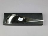 a black box with a knife in it on a table