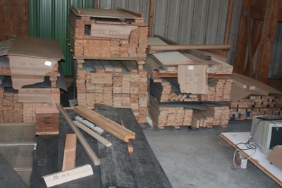 several stacks of wood are stacked on top of each other in a warehouse