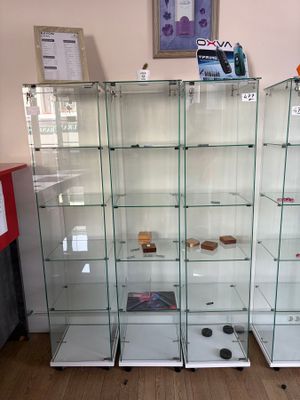 many glass shelves in the corner of a room