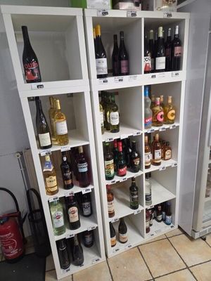 many bottles of wine on the shelves in the kitchen