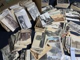 a lot of old black and white photos on a table