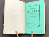 an open book with a wooden stick sticking out of it