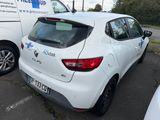 a white car parked in a parking lot next to a white van