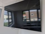 a flat screen tv mounted on the wall in a room