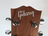 a close up of the headstock of a guitar with the gibson logo on it