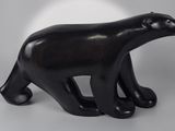 black sculpture of a polar bear on a white background