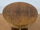 a small round table with a wooden base