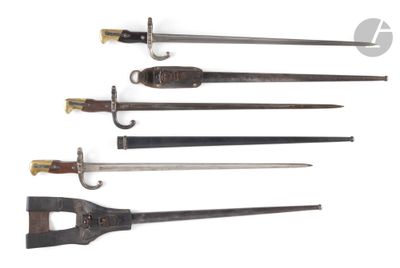 four different types of swords are displayed on a white surface