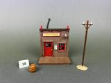 a small wooden building with a sign on the front of it