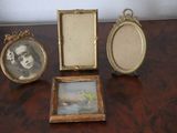 three picture frames sitting on a table next to each other