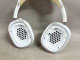 a pair of white headphones sitting on top of a table